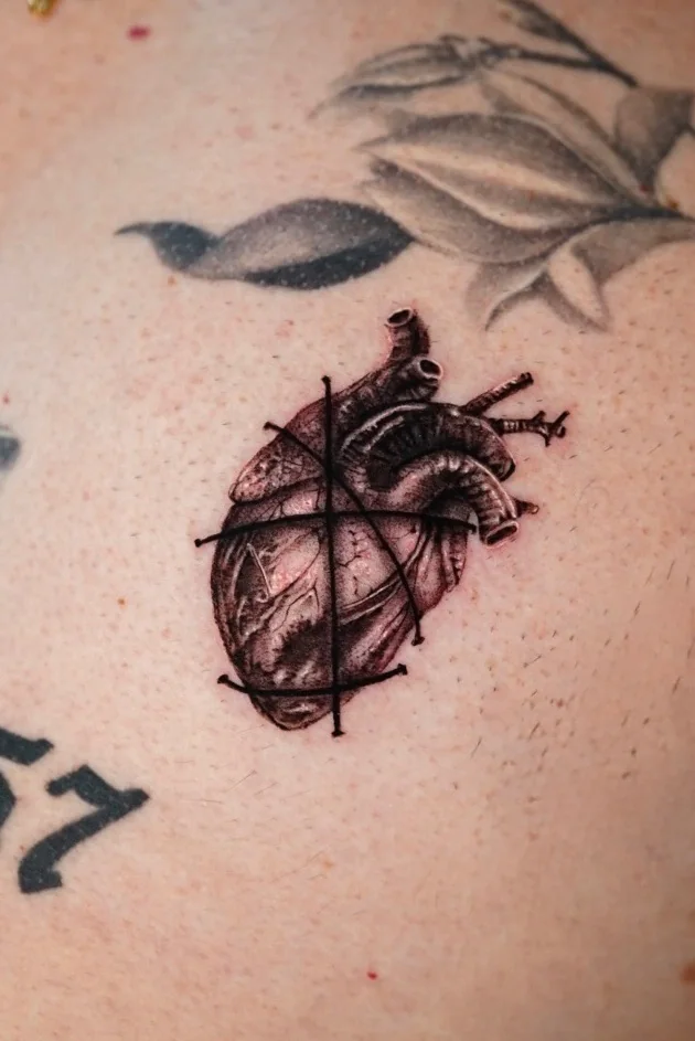 Anatomical heart tattoo with fine crosshair lines